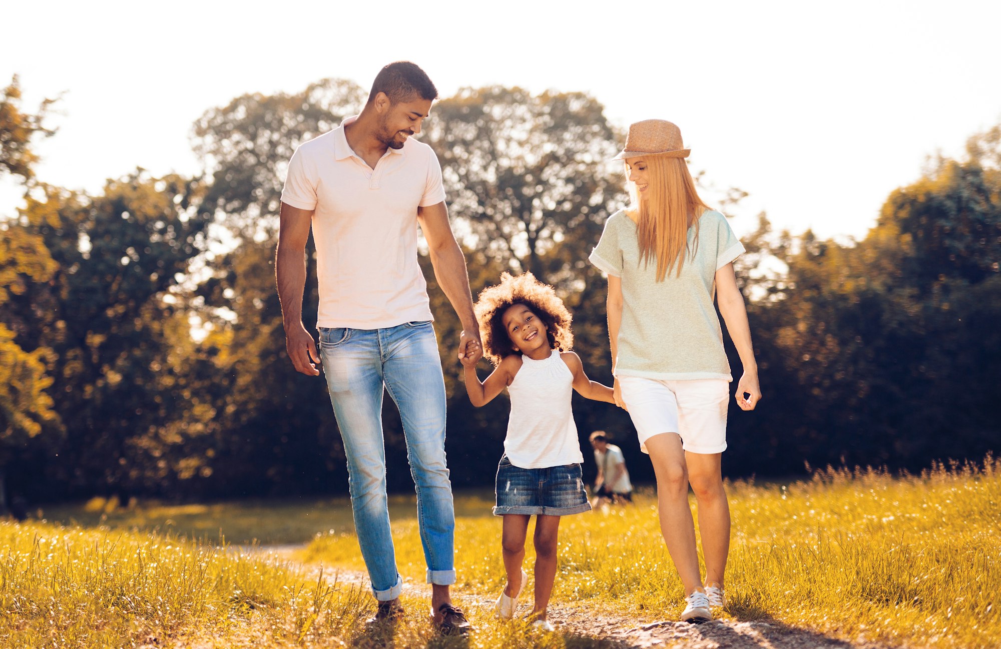 Happy family walking in nature with child