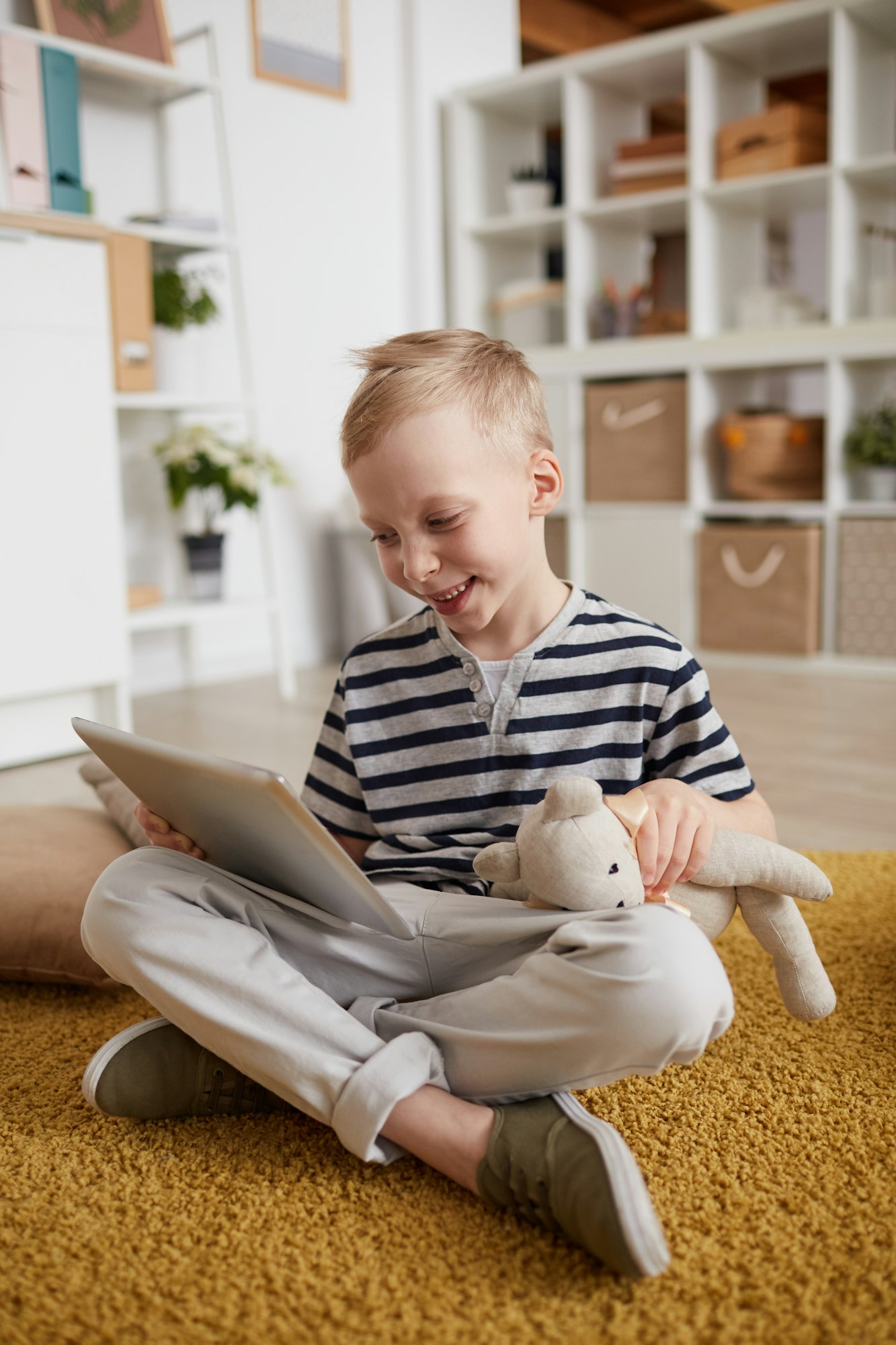 Happy boy using tablet at home