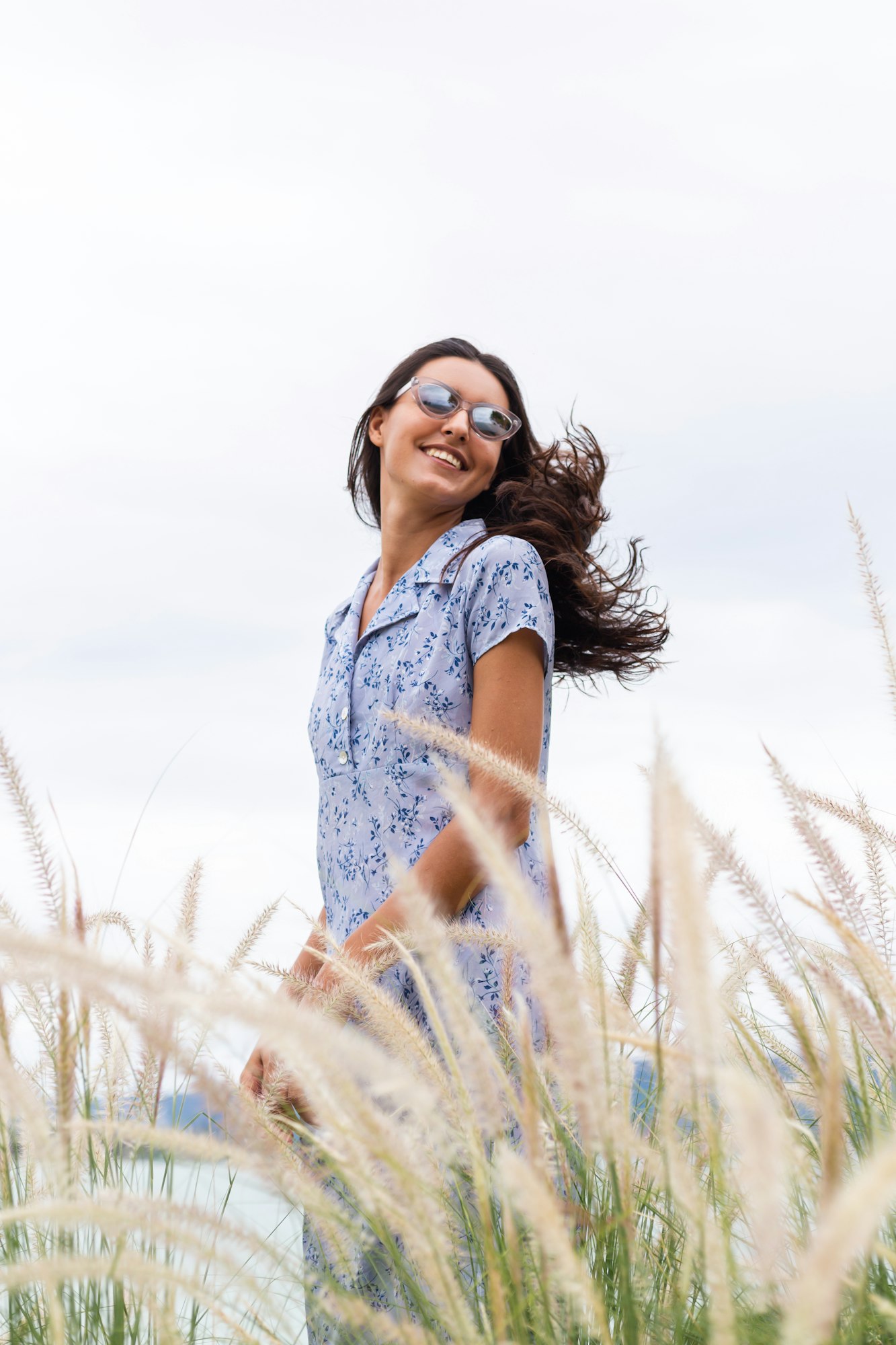 Portrait of sensetive romantic woman wearing cute blue dress on wheat field