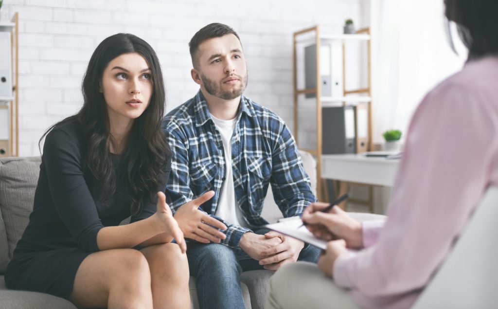 Young couple discussing their problems at marital therapy